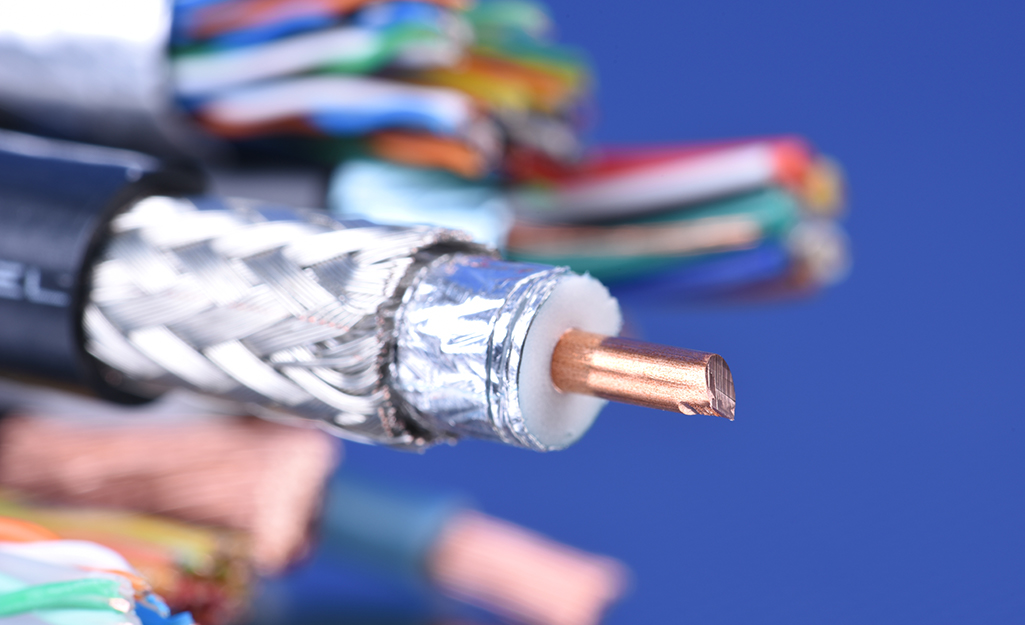 A stripped coaxial cable with other stripped cables in the background.