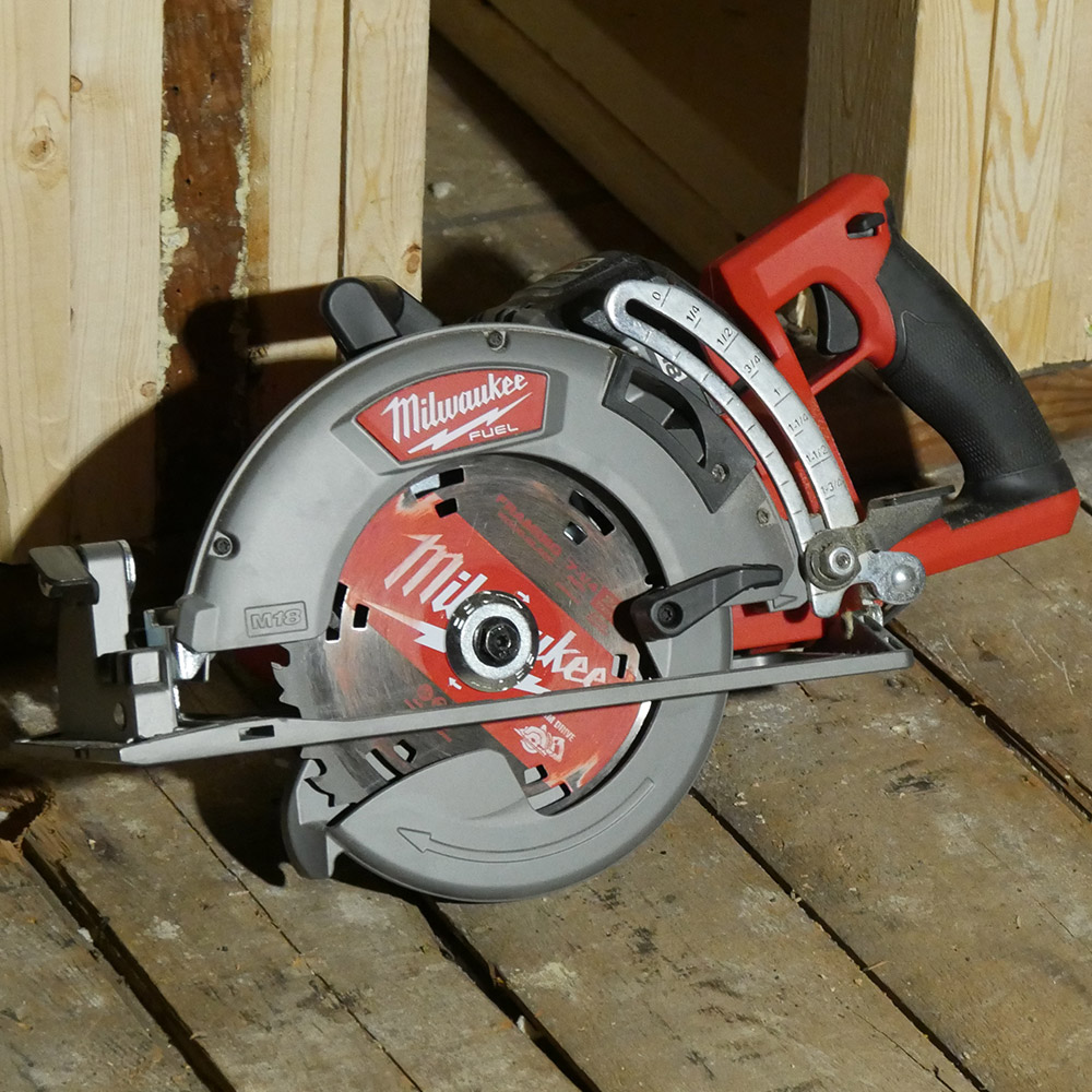 A saw on wooden plank floor.