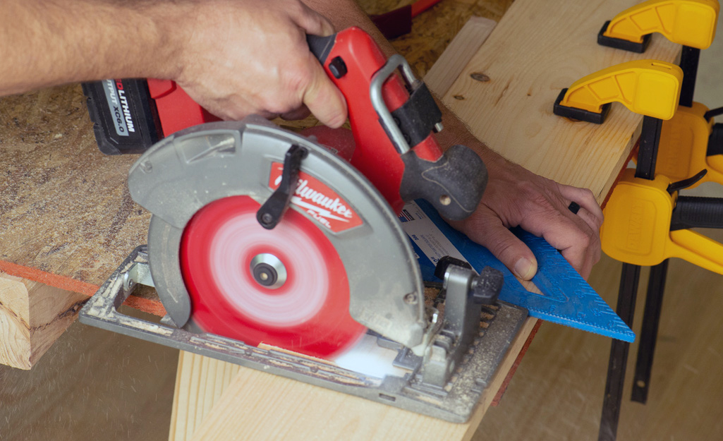 A person ripping with circular saw.