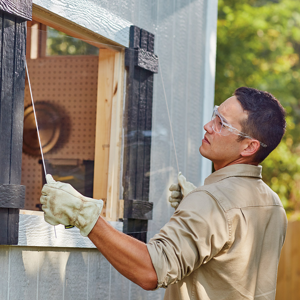 Person holding plexiglass sheeting