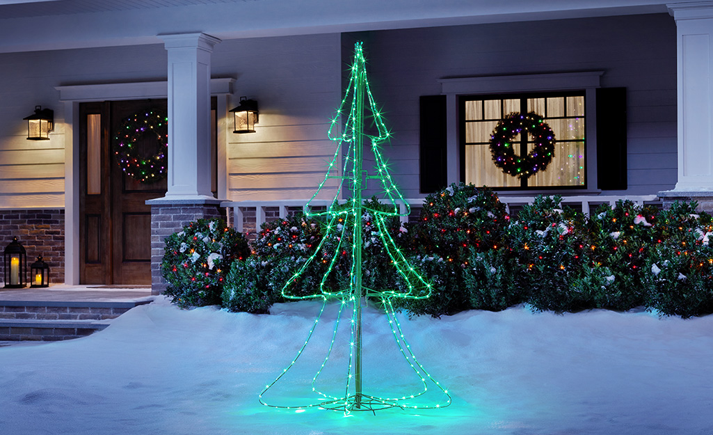 A Christmas tree light display outside a home.