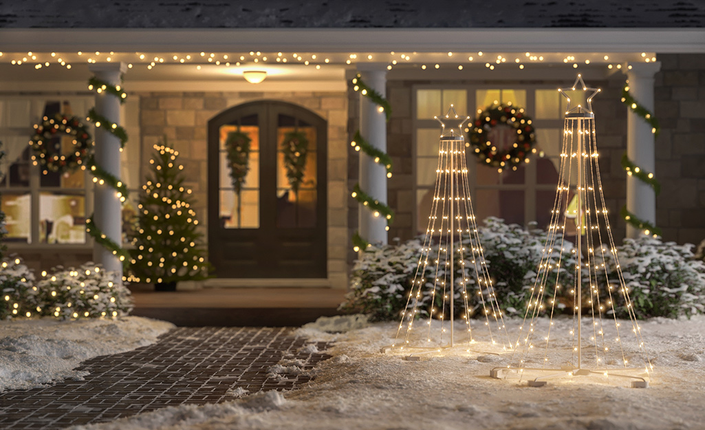 A front of a home well-lit with Christmas lights and decor.