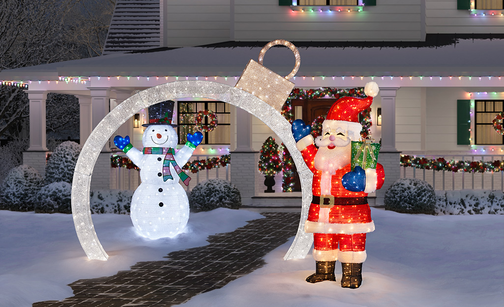 Snowman, Santa and other Christmas lights displayed outside a home..