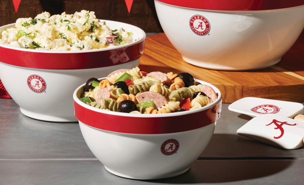 Game day foods in bowls with sports logos. Game day foods in bowls with sports logos.
