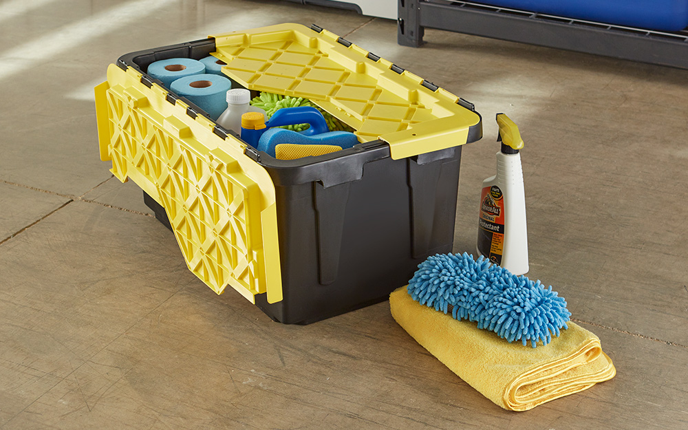Cleaning supplies from a car care kit sit next to a box with additional supplies.