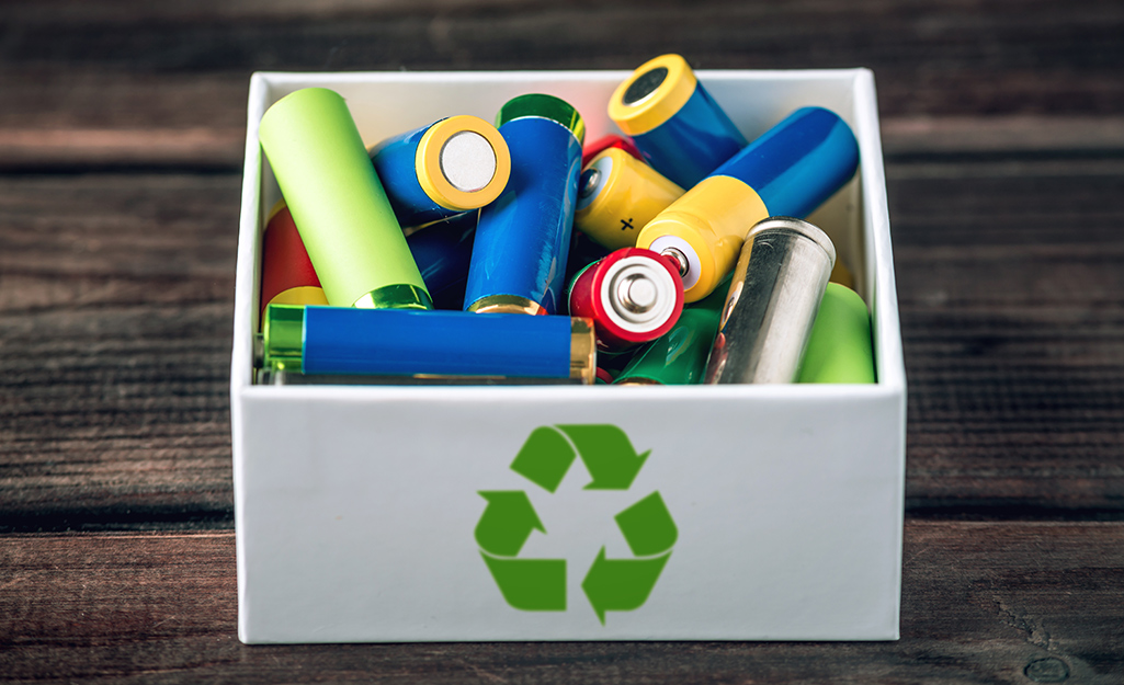 Batteries filling a recycling bin. Batteries filling a recycling bin.