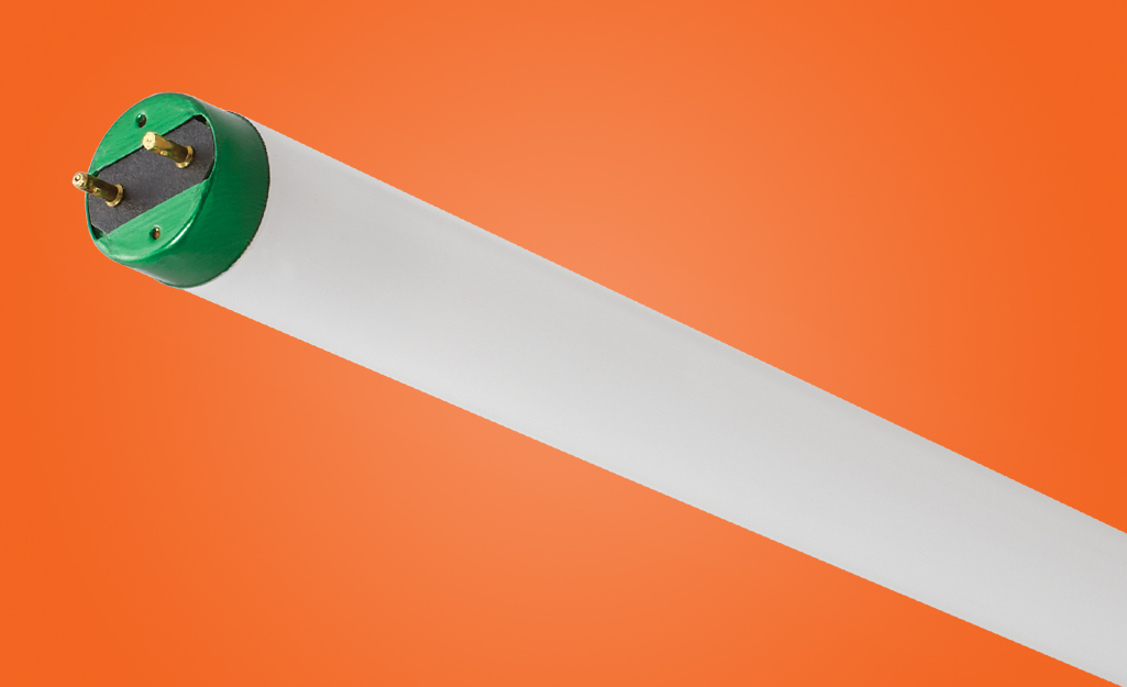 A fluorescent tube light on an orange background.