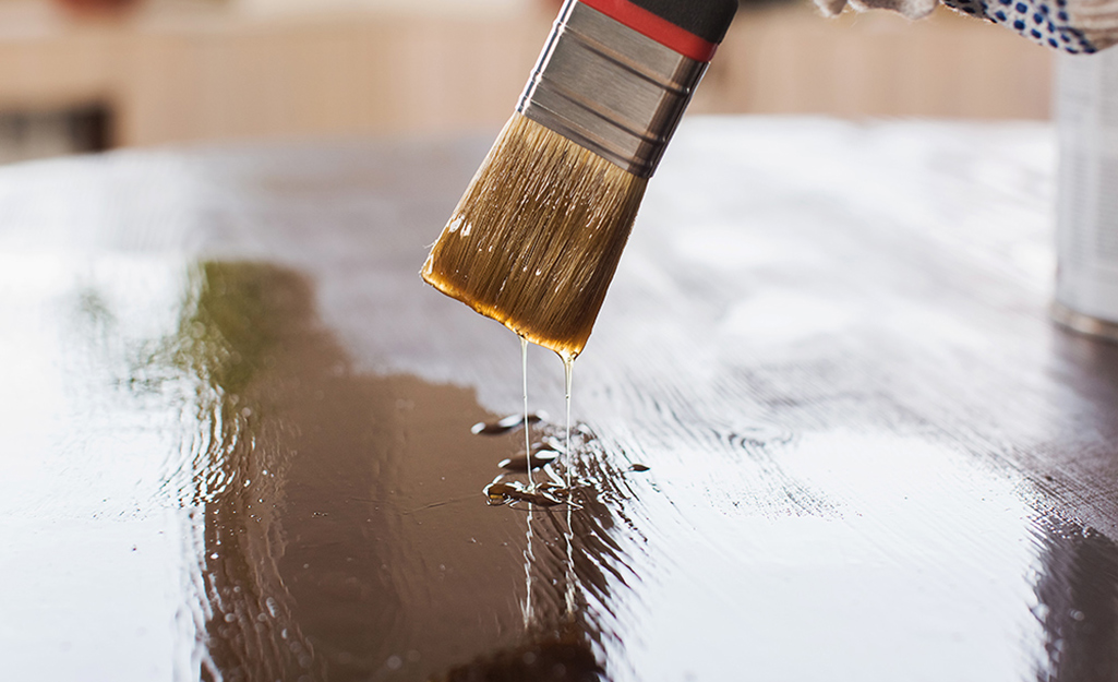 A sealer is applied to wood.