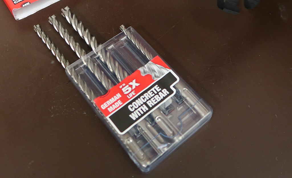 A container of drill bits on a table.