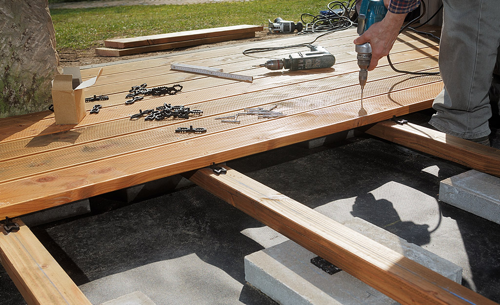 Boards are nailed down to create a deck. 