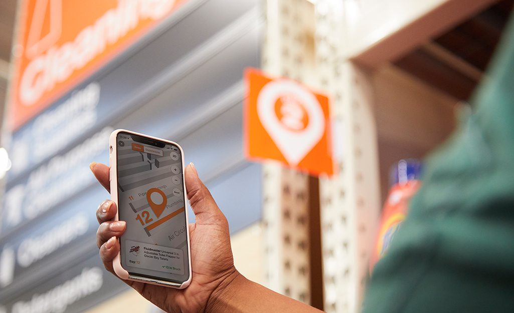 Woman looking at The Home Depot Mobile app Product Locator feature