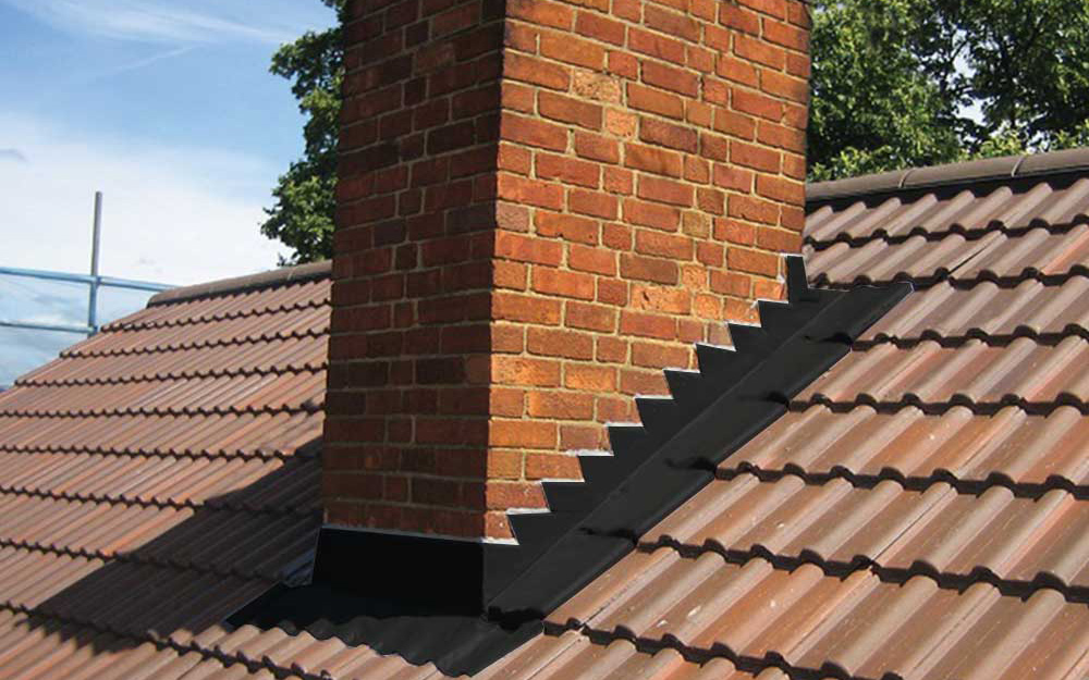 Step flashing is used around the chimney on a roof to conceal the seam between the brick and the roof surface.