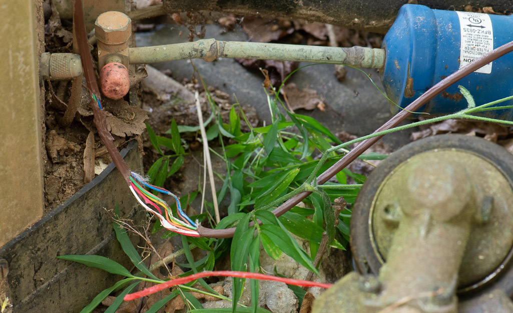 A thermostat wire has been damaged by a string trimmer.