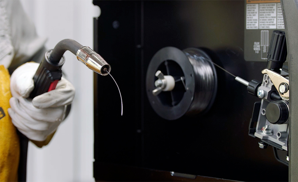 A person holding a welding tool. 