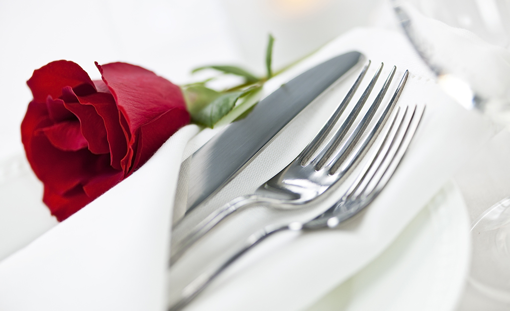 A knife and two forks tucked into a pocket napkin fold. A knife and two forks tucked into a pocket napkin fold.