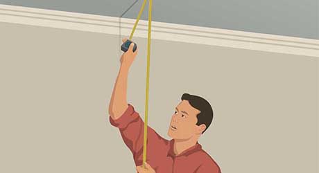 Person measuring stud length between ceiling and floor with tape measure Person measuring stud length between ceiling and floor with tape measure