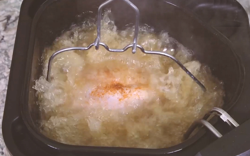 A turkey frying in an indoor turkey fryer. A turkey frying in an indoor turkey fryer.