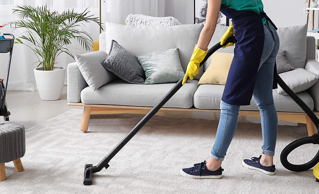 Woman vacuuming her living room.
