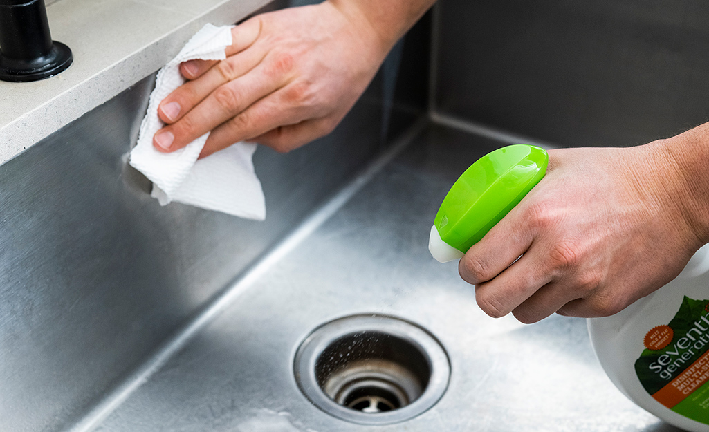 Someone cleaning a kitchen sink.