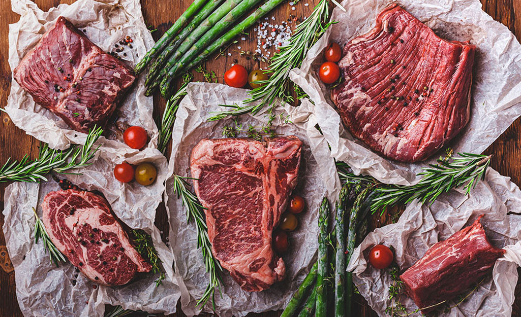 Various cuts of steak on a cutting board.