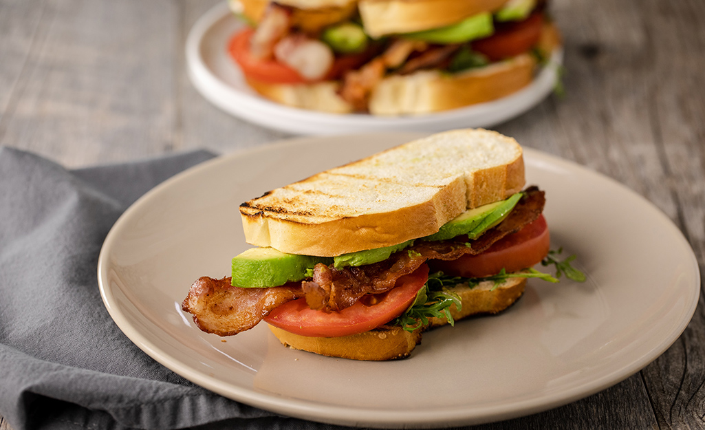 Avocado, bacon and tomato sandwich on toast Avocado, bacon and tomato sandwich on toast