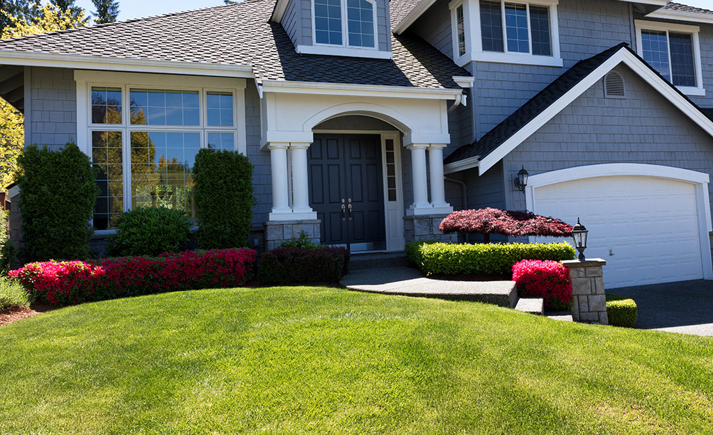 A home with thick green grass in the front yard.