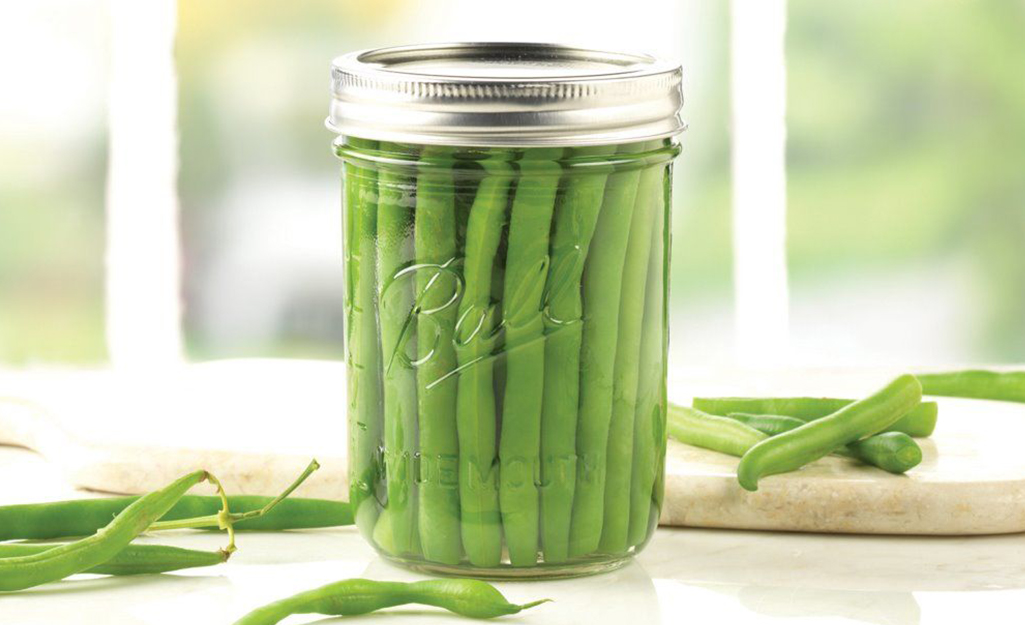 Green beans in a glass jar.