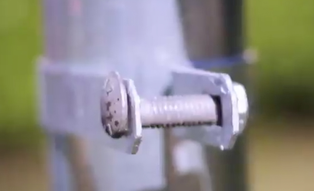 A bolt being attached to a chain-link fence. A bolt being attached to a chain-link fence.
