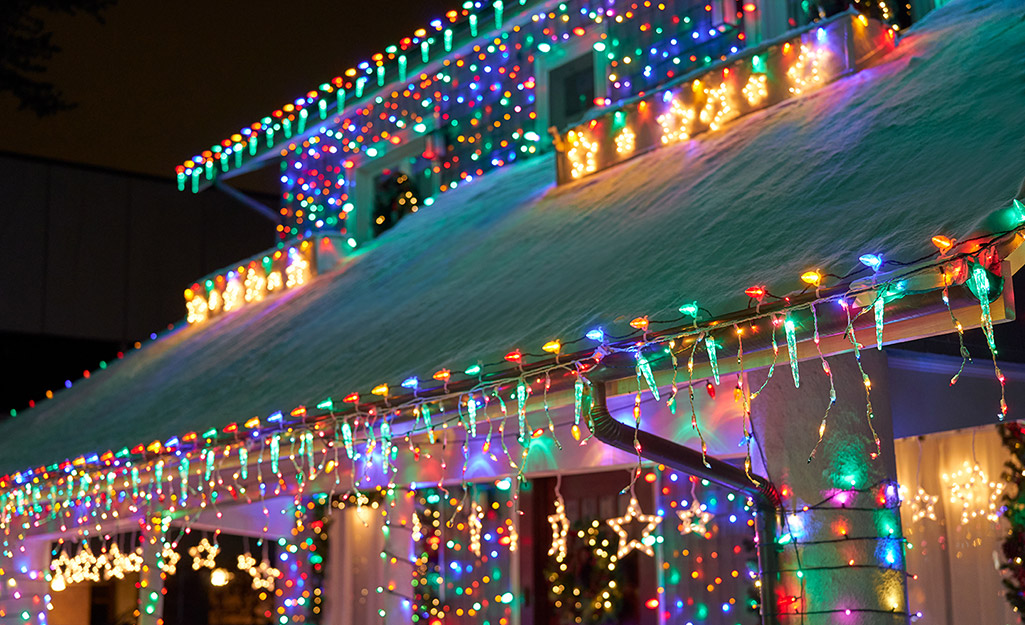 A house decorated with hanging Christmas lights.