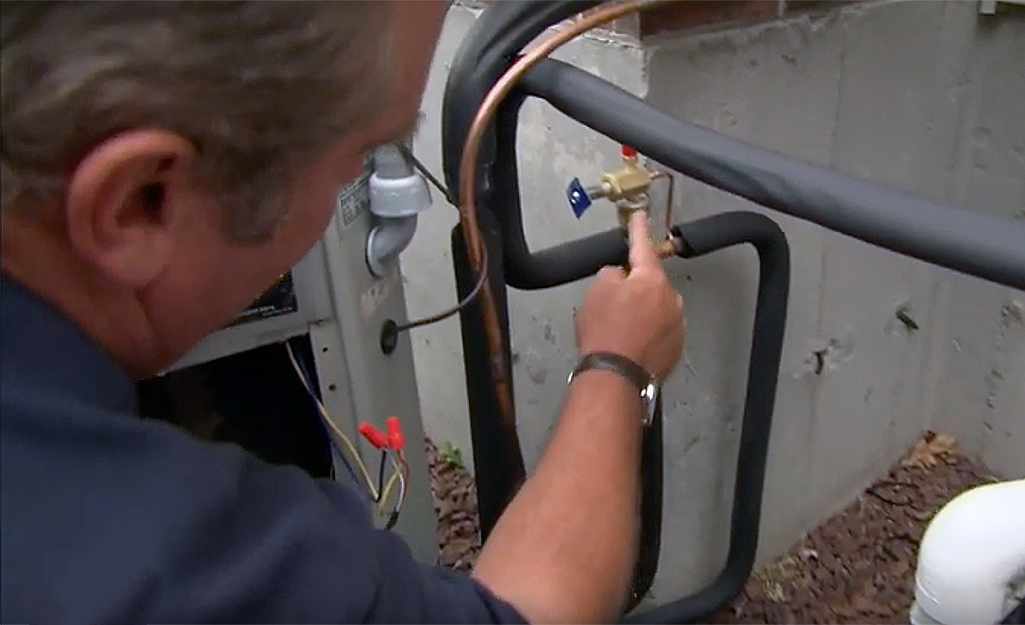 A man pointing to the fittings on a pipe A man pointing to the fittings on a pipe