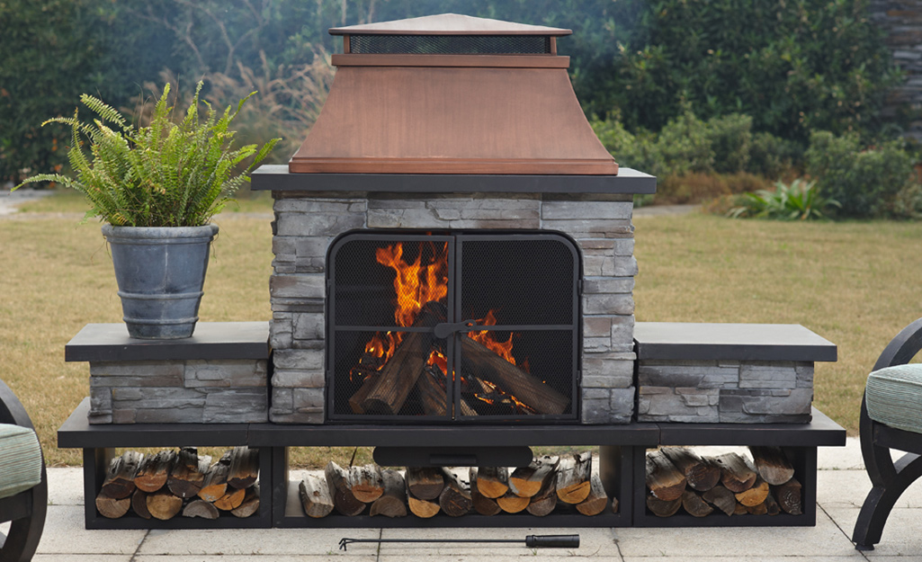 A wood-burning fireplace at the edge of a patio.