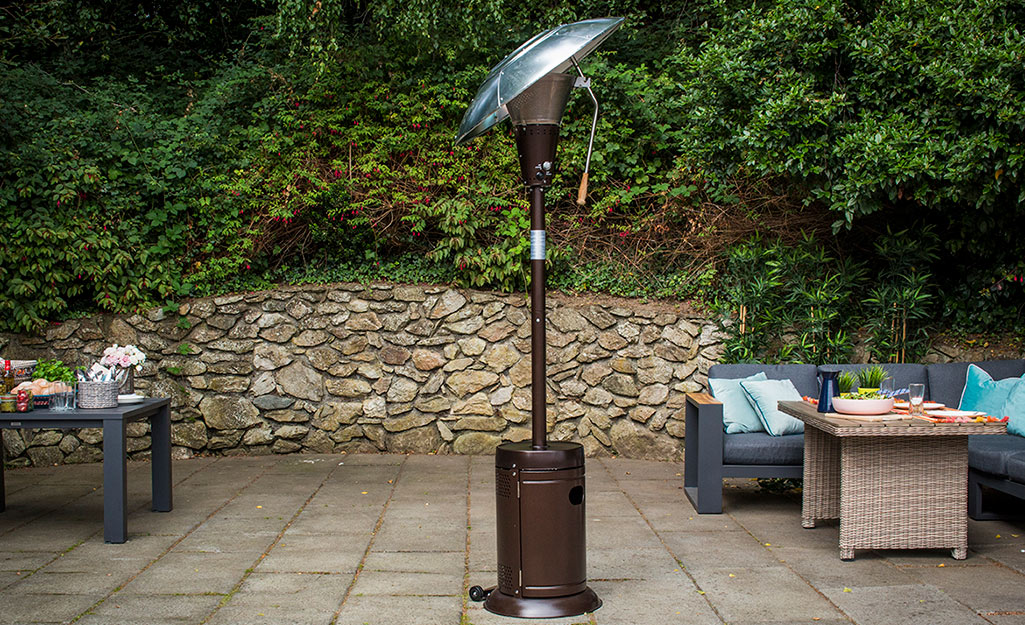 A tall outdoor patio heater on a large patio.