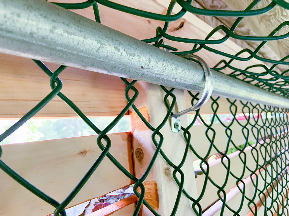 A close shot of the wood frame connected to the fence