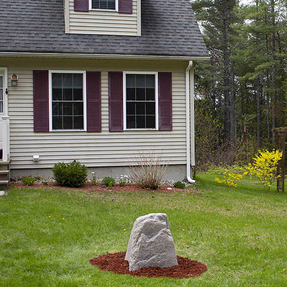 A front yard with rock enclosure surrounded by mulch.
