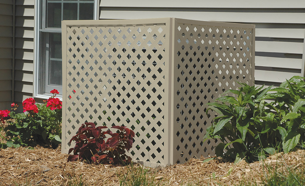 A whole home a/c unit among various plants