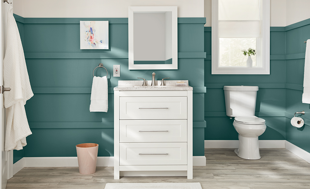 A framed bathroom mirror over a vanity.