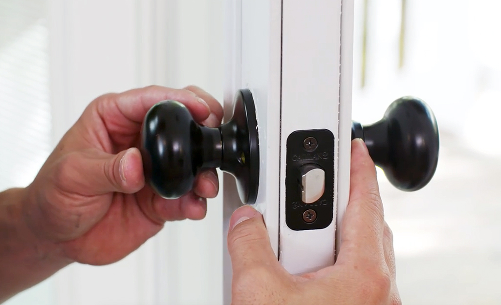 A new lock is installed on a door.