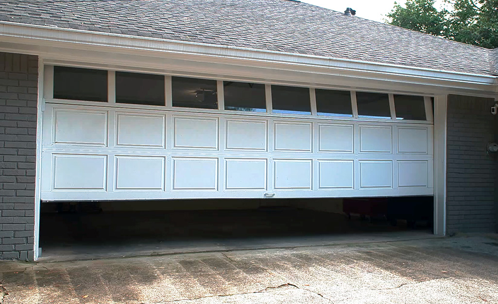 A white garage door opens.