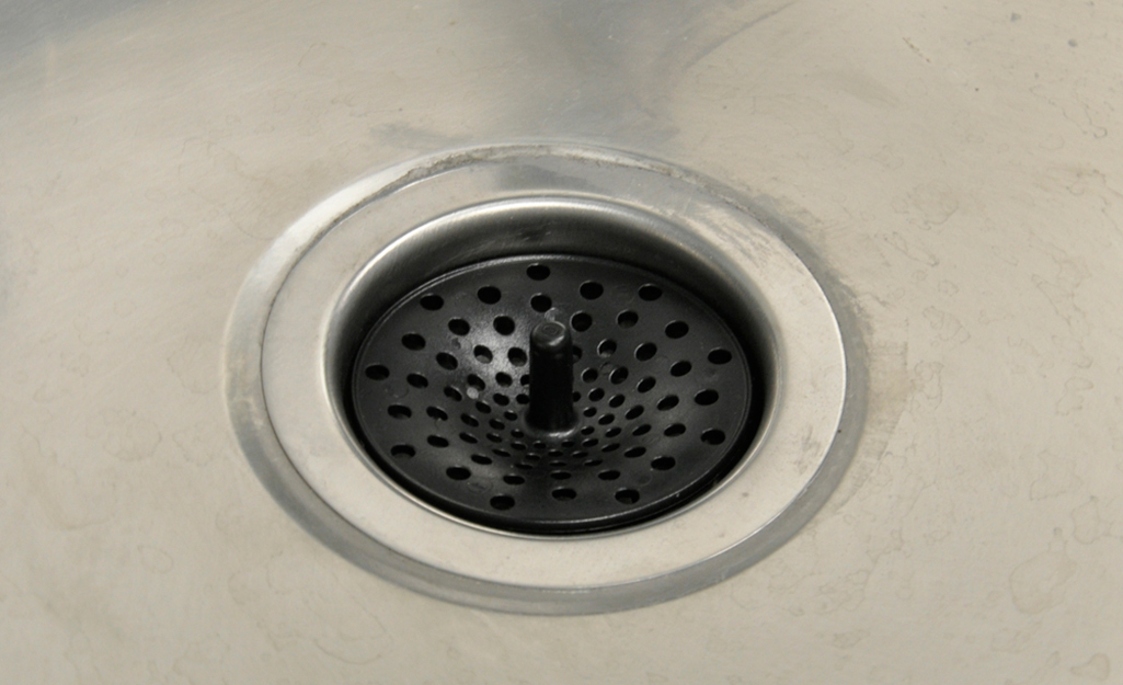 A drain flange at the bottom of a sink.