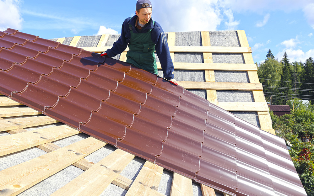 Man installing a metal roof