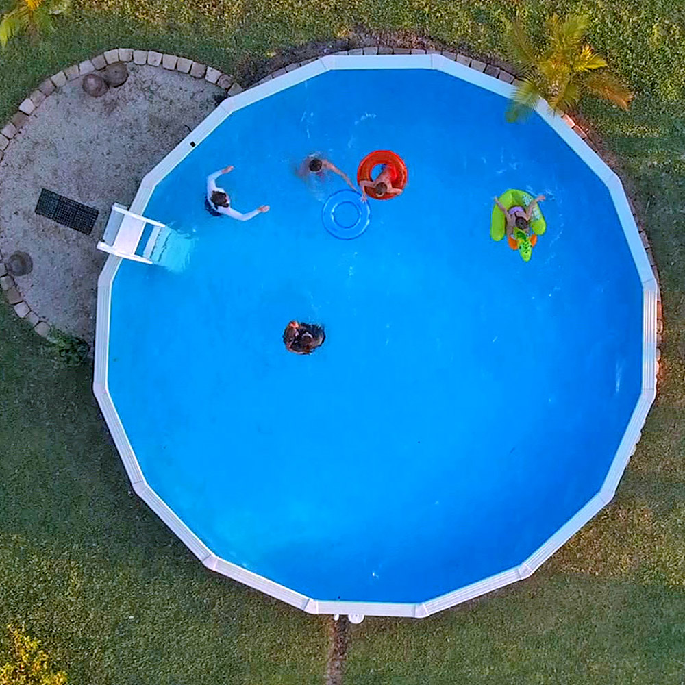An aerial view of an above-ground pool in a backyard. 
