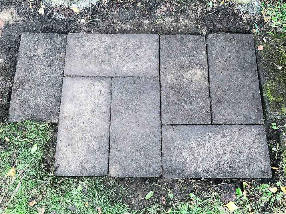 A group of pavers leveled in grass.