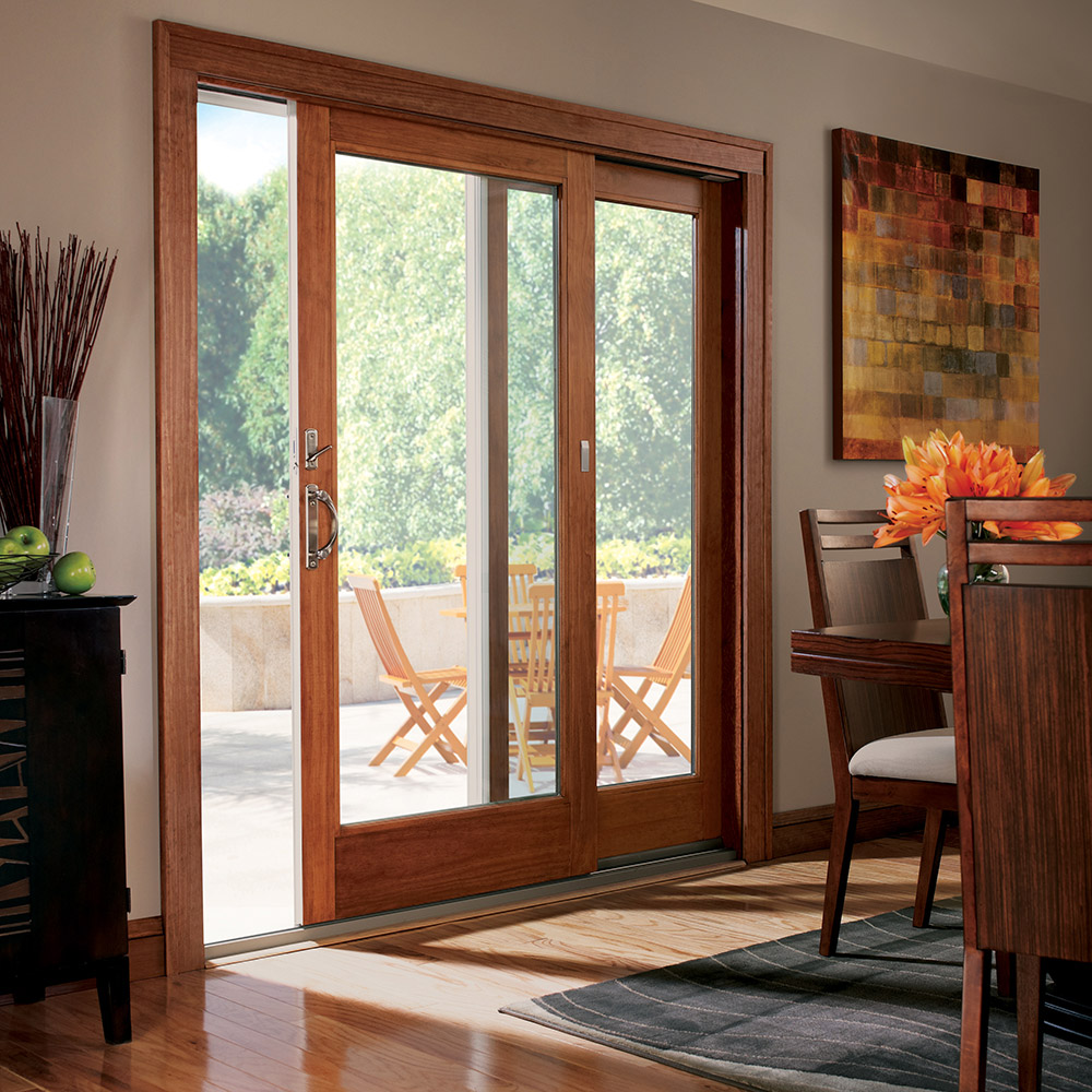 A sliding door with a wooden frame leads to a patio.