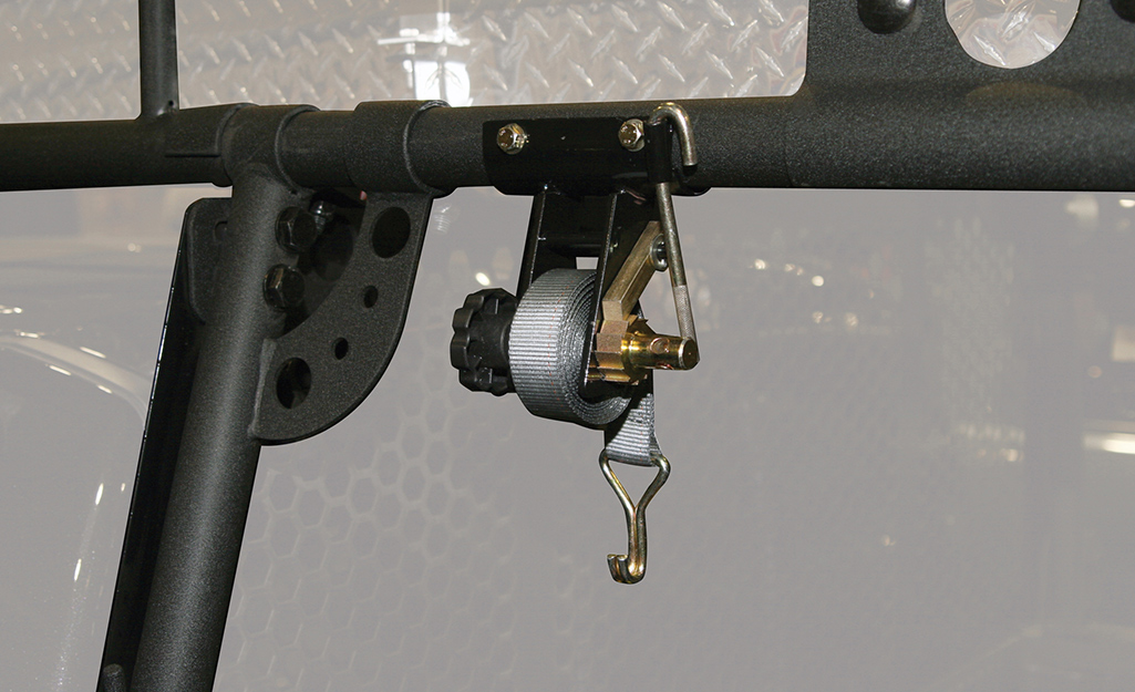 A J-hook hangs in the back of a truck.