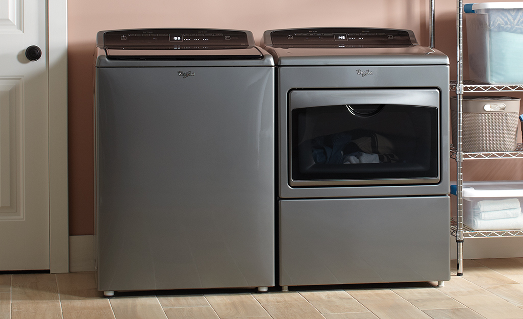 A washer and dryer with leveling feet in a laundry room.