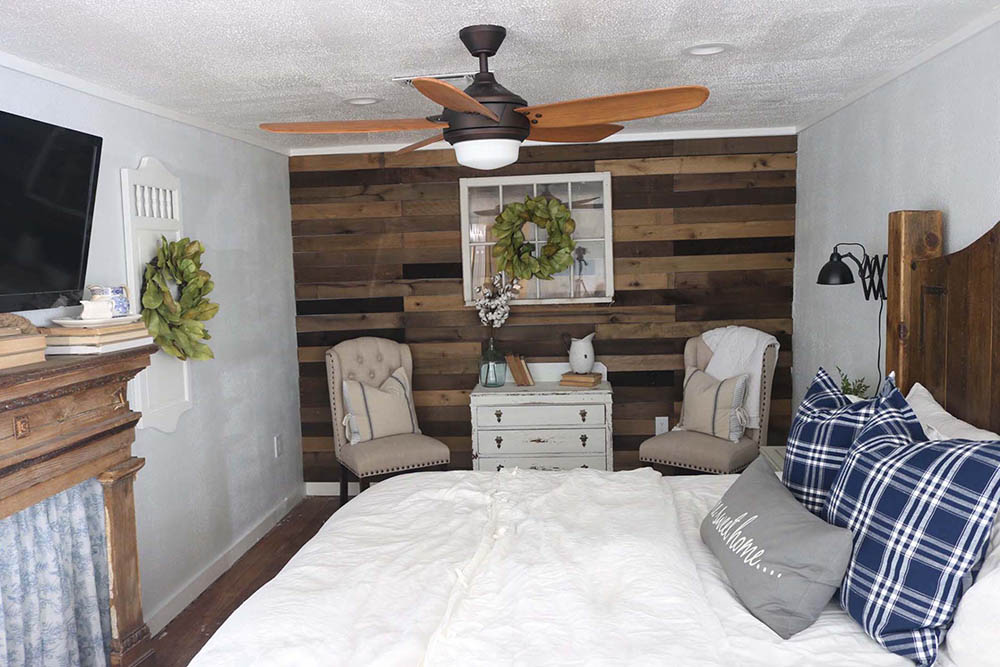 An updated bedroom with a weathered wood accent wall. An updated bedroom with a weathered wood accent wall.