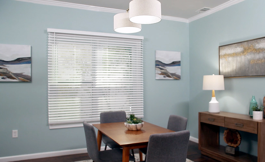 Faux wood blinds on windows in a dining area.
