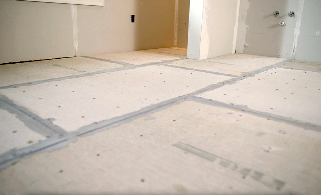 A floor of new cement backboard dries before tile installation.