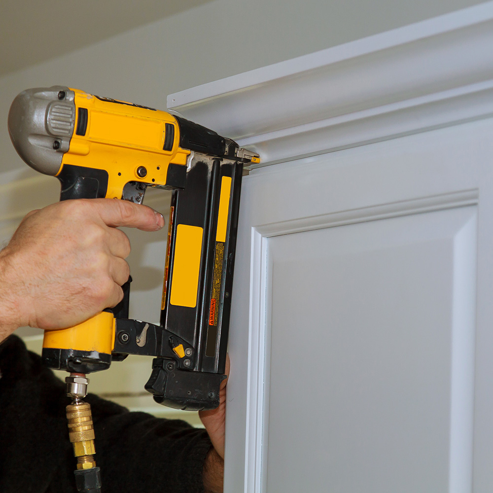 Installing crown molding with a pneumatic nailer.