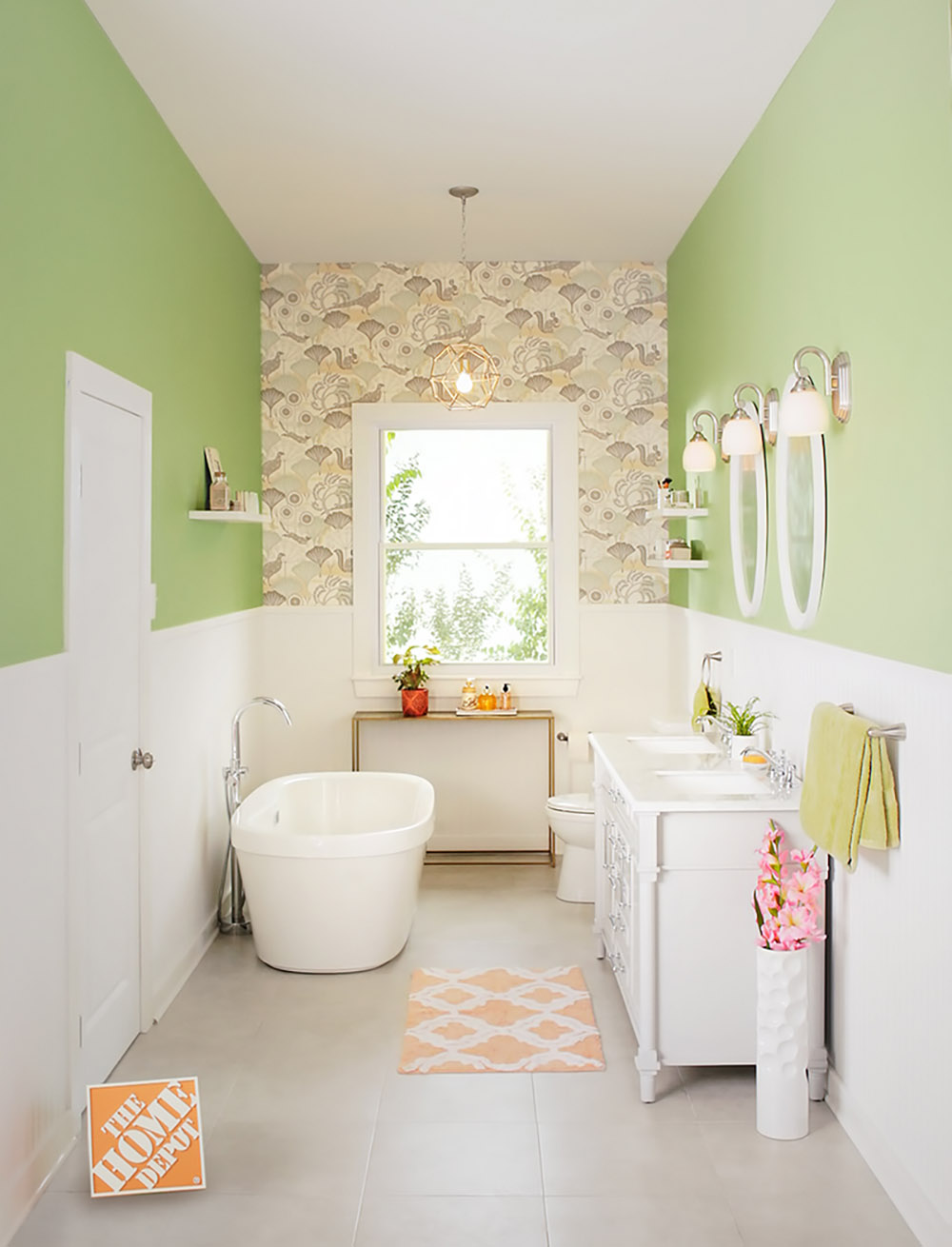 A bathroom with a floral accent wall and window.